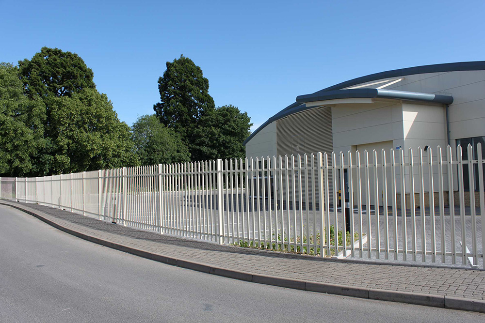 white painted palisade fencing around school