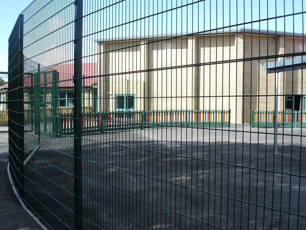 Green mesh fencing and gates at a school