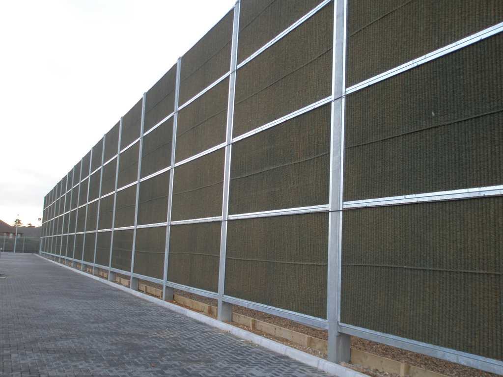 Timber acoustic barrier beside a road
