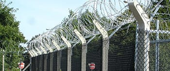 School fencing image of palisade fencing with barbed wire