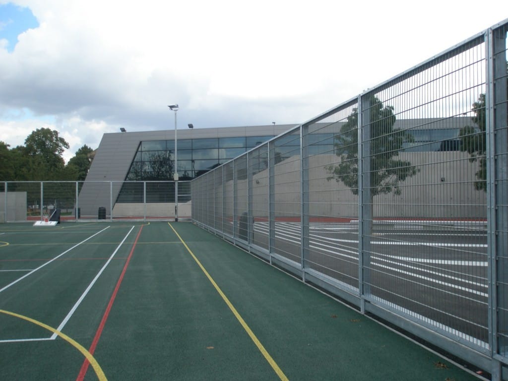 Rigid mesh fencing surrounding school sports court