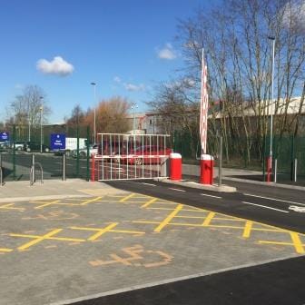 car park entrance gate and surrounding mesh fencing